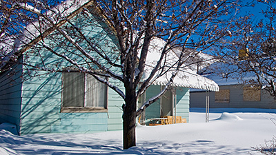 Picture of a weatherboard house in the snow, in Park City, Utah